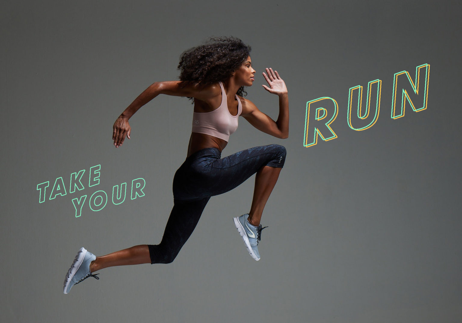 female athlete shot in striking pose against stylised backdrop